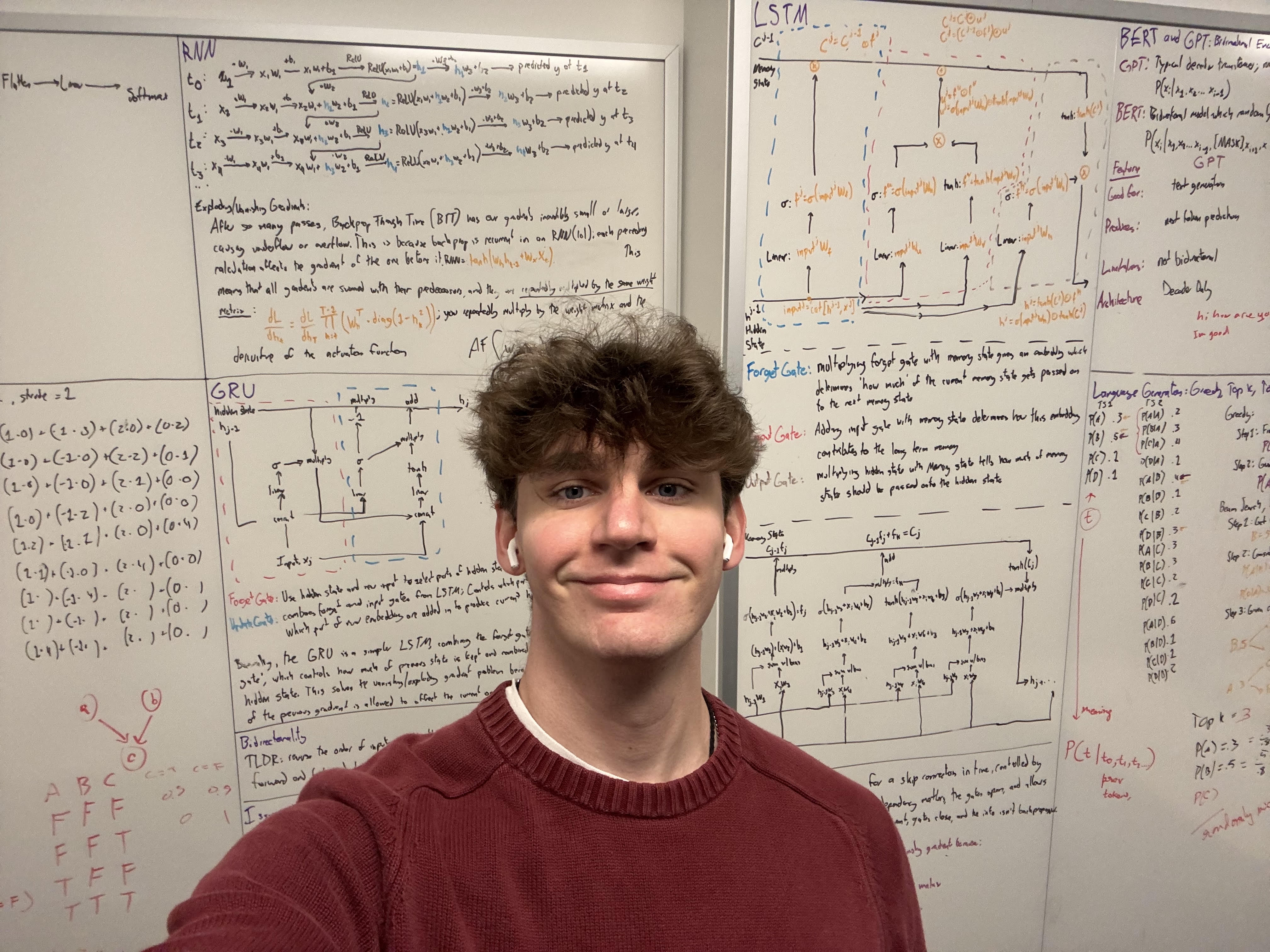 Portrait of Dom Marhoefer in front of a whiteboard with neural network notes